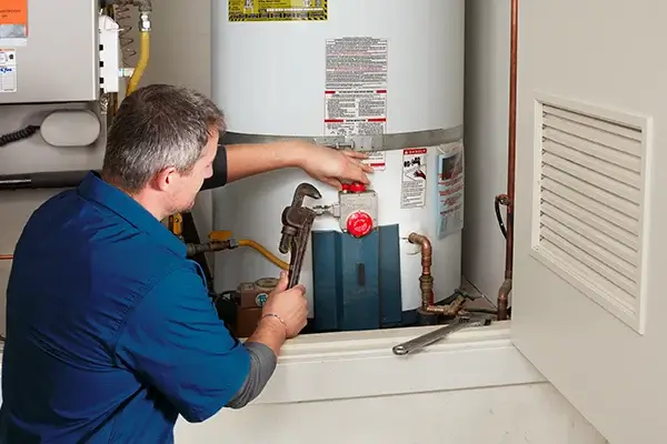 Professional technician repairing a gas water heater